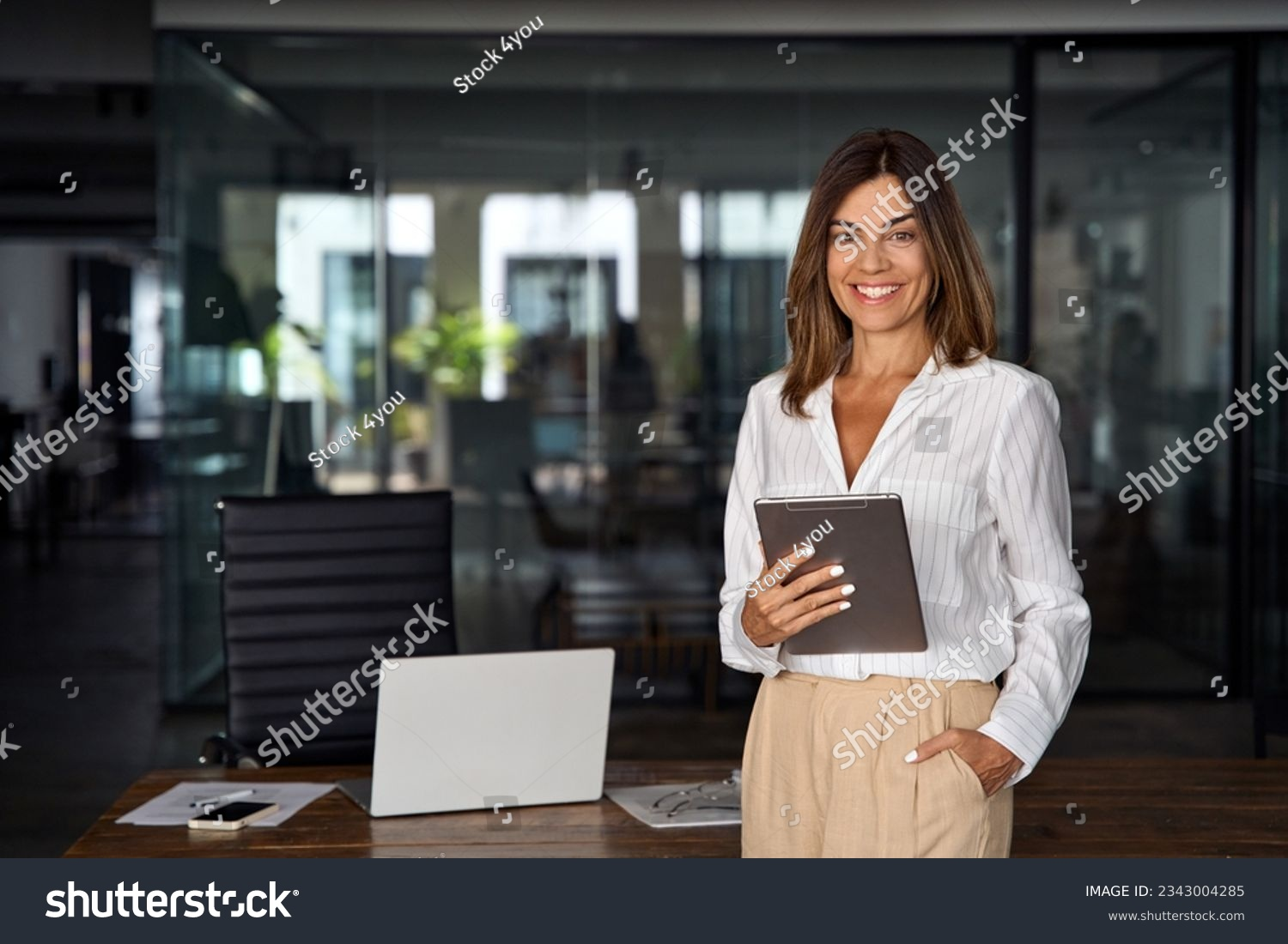 businesswoman holding clipboard outside a business